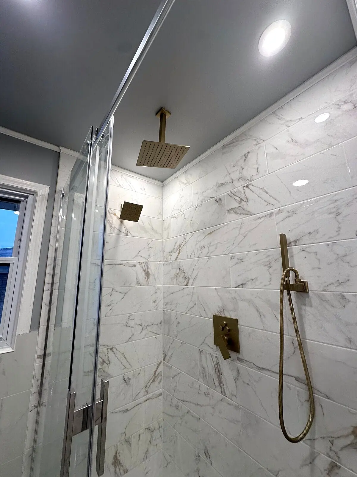 Luxury bathroom after renovation — gold rain shower