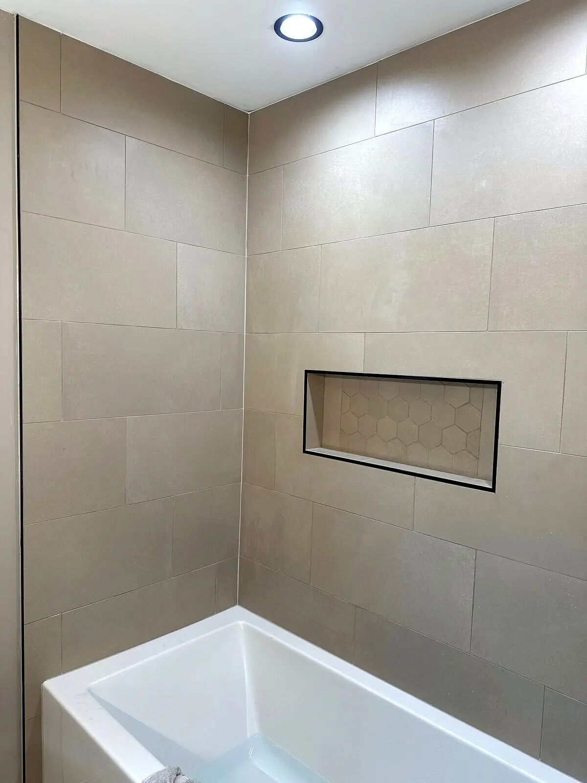 Freestanding soaking tub with marble surround
