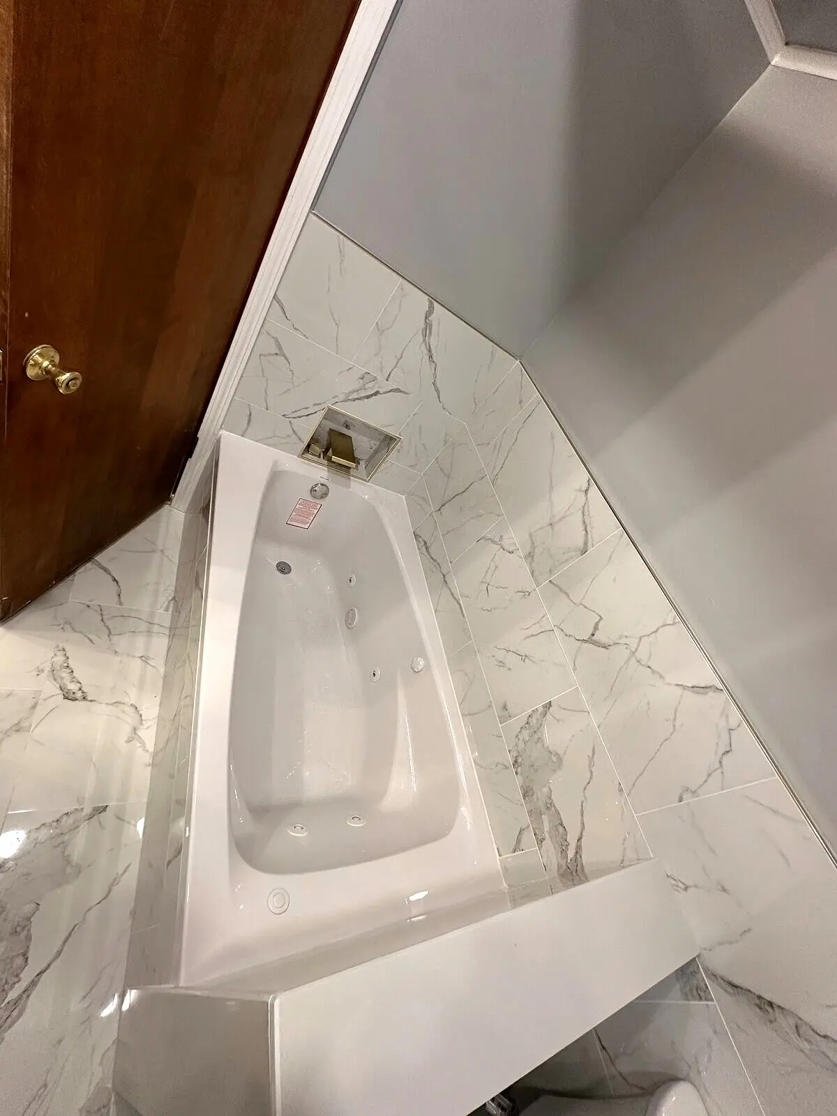 Designer vanity with sconce lighting and marble backdrop